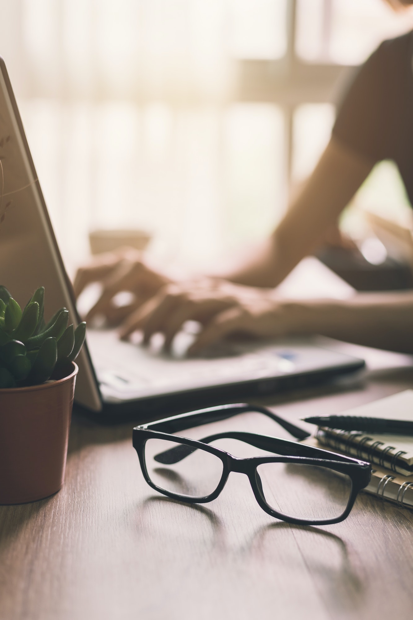 Businesswoman typing on laptop at workplace